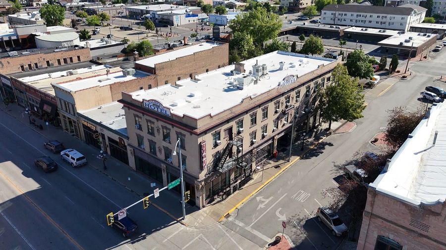 Kalispell Grand Hotel — three-quarter aerial over First Street with the rooftop sign