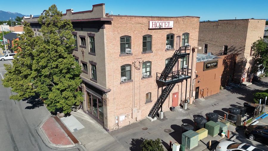 Kalispell Grand Hotel — close aerial of the brick facade, HOTEL sign and fire escape